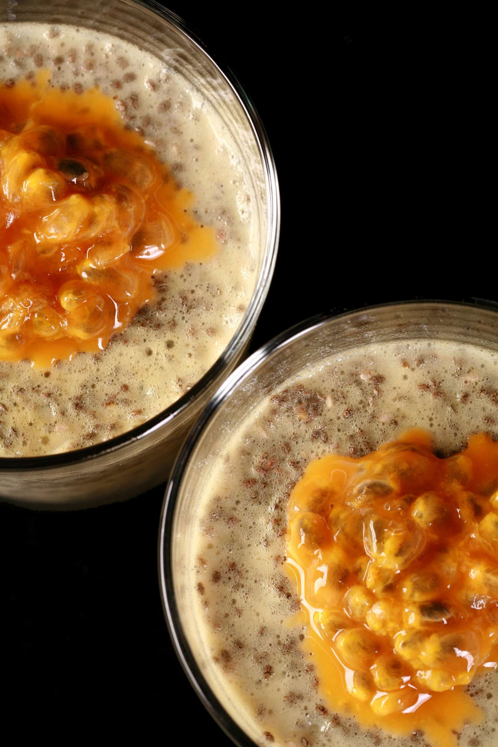 2 glasses of keto passion fruit protein pudding, topped with fresh passionfruit.