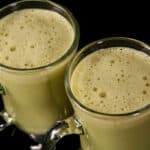 2 protein matcha lattes in glass mugs.