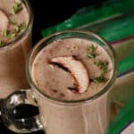 2 mugs of protein powder cream of mushroom soup, with pouches of soup mix beside them.