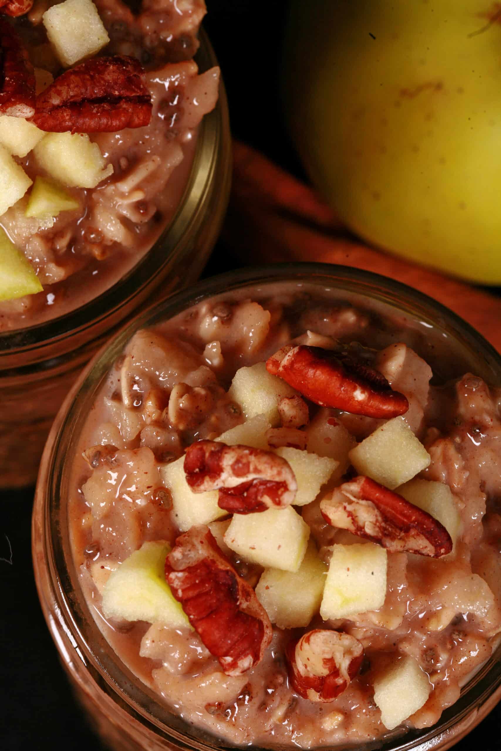2 jars of high protein apple pie overnight oats, topped with chopped apples and pecans.
