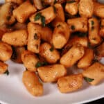 A plate of high protein sweet potato gnocchi with sauteed mushrooms and sage.