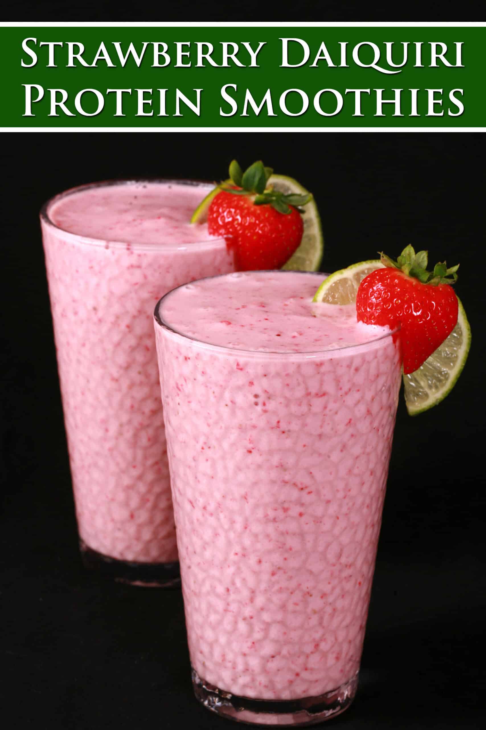 2 tall glasses of non-alcoholic high protein strawberry daiquiri smoothies, garnished with a fresh strawberry and a slice of lime. Overlaid text says strawberry daiquiri protein smoothies.