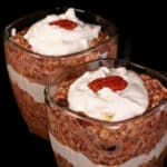 2 glasses of high protein carrot cake overnight oats parfaits, with layers of cream cheese and Greek Yogurt.