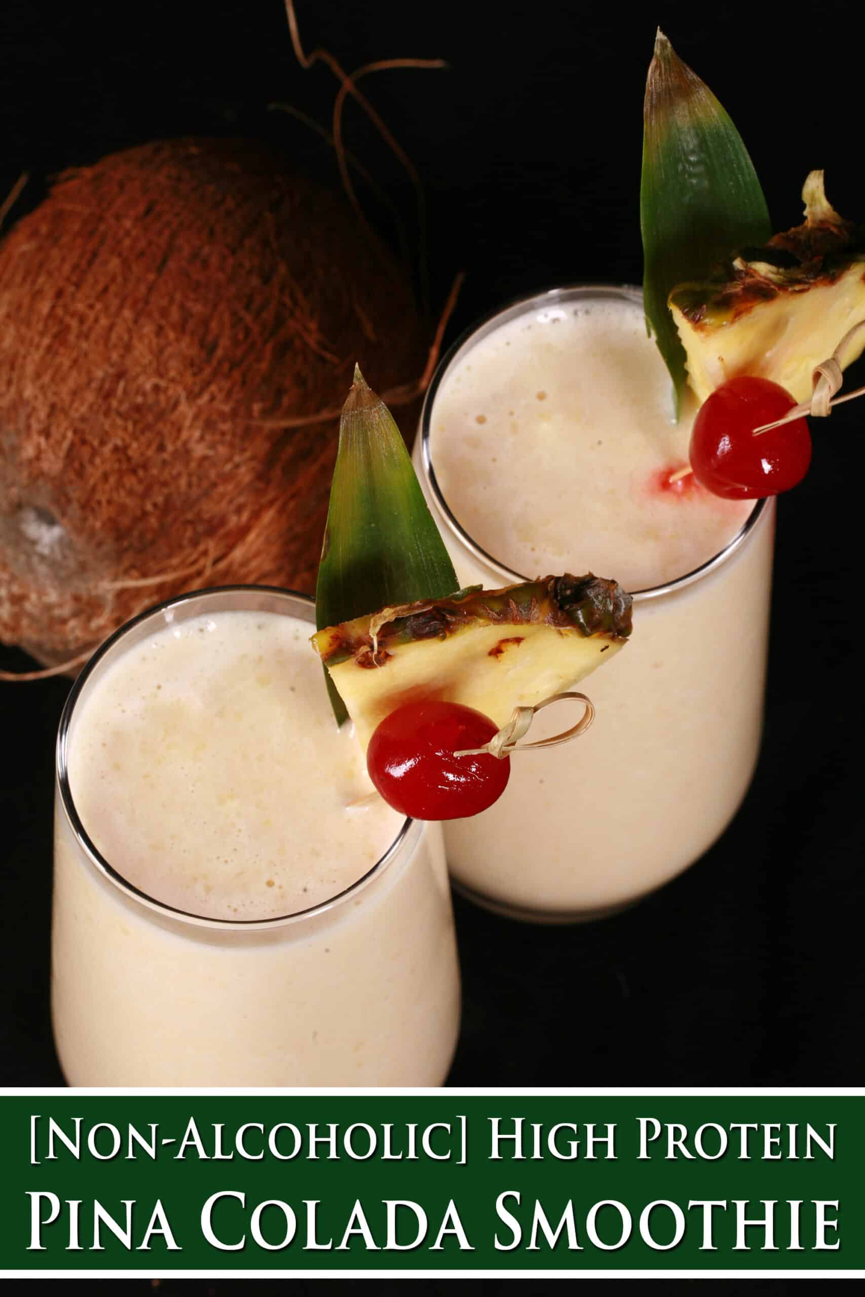 2 Pina Colada Protein Smoothies garnished with a pineapple wedge and cherry. Overlaid text says non-alcoholic high protein pina colada smoothie.
