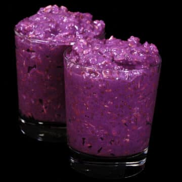 2 mason jars of bright purple high protein Ube Overnight Oats.