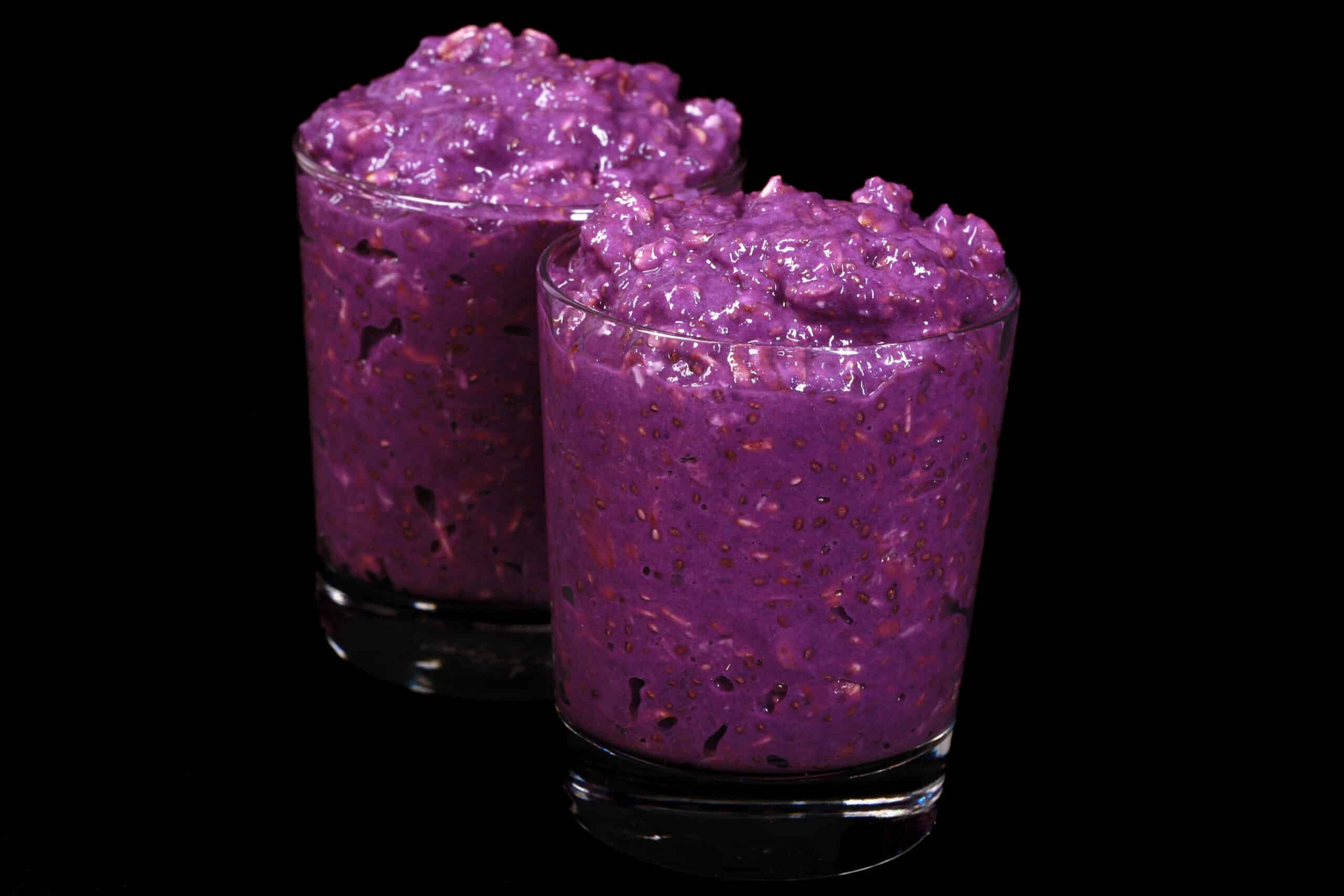 2 mason jars of bright purple high protein Ube Overnight Oats.