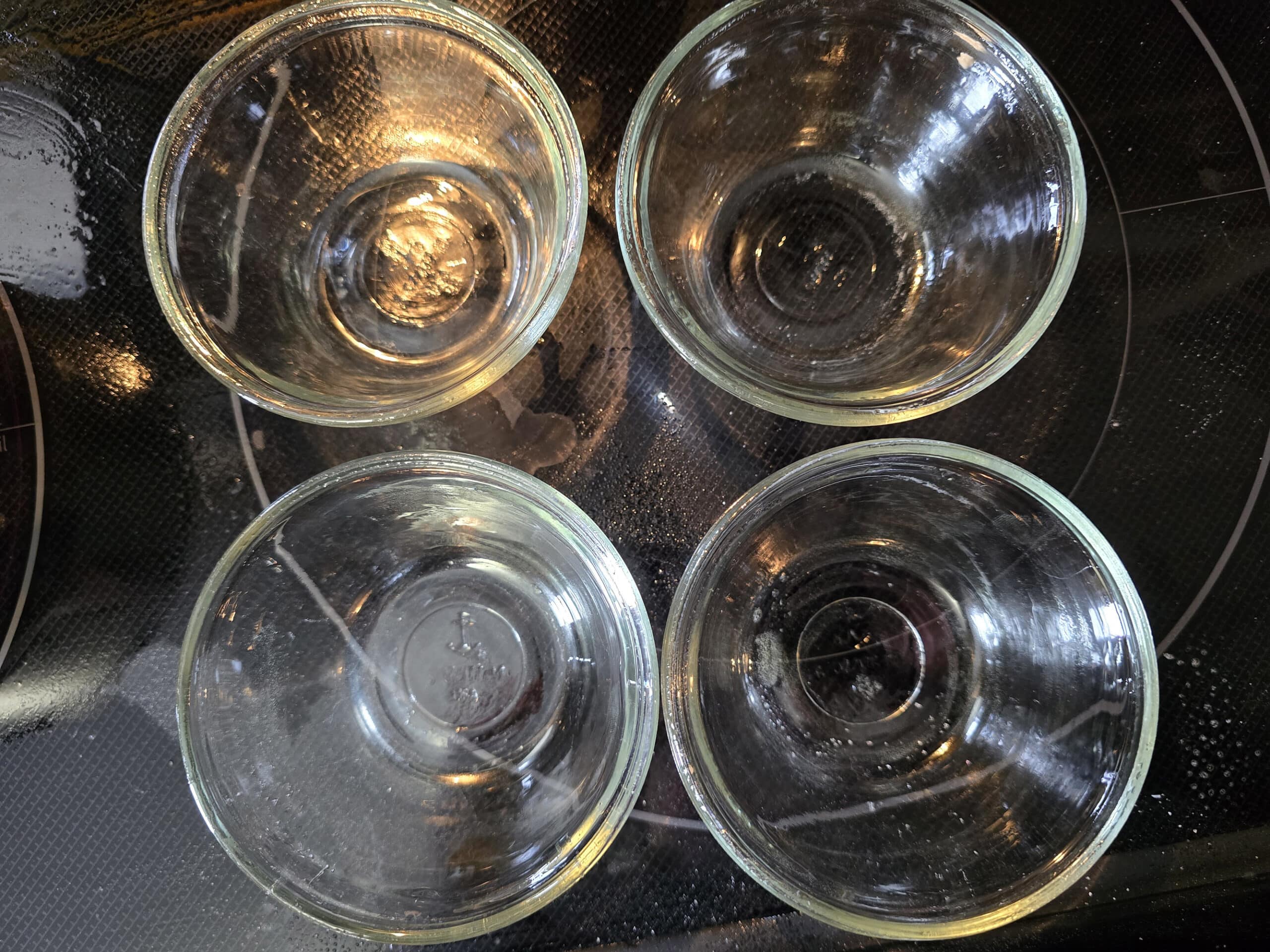 4 glass dessert cups after being greased.