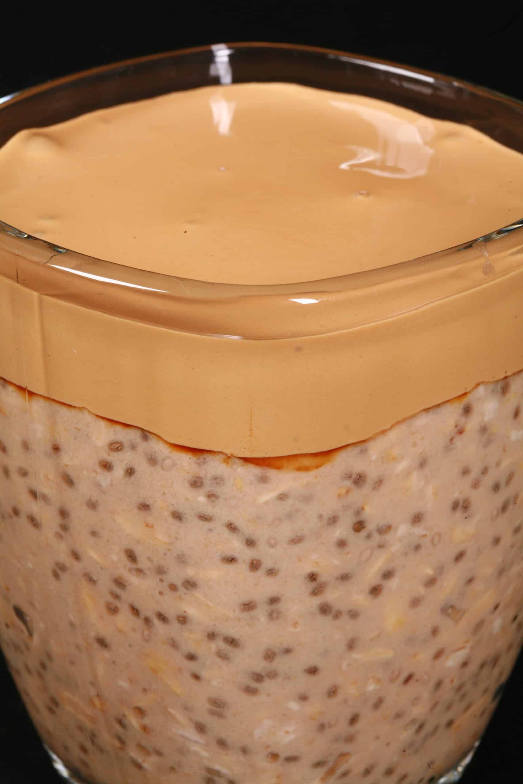 A mug of Dalgona Coffee High Protein Overnight Oats.