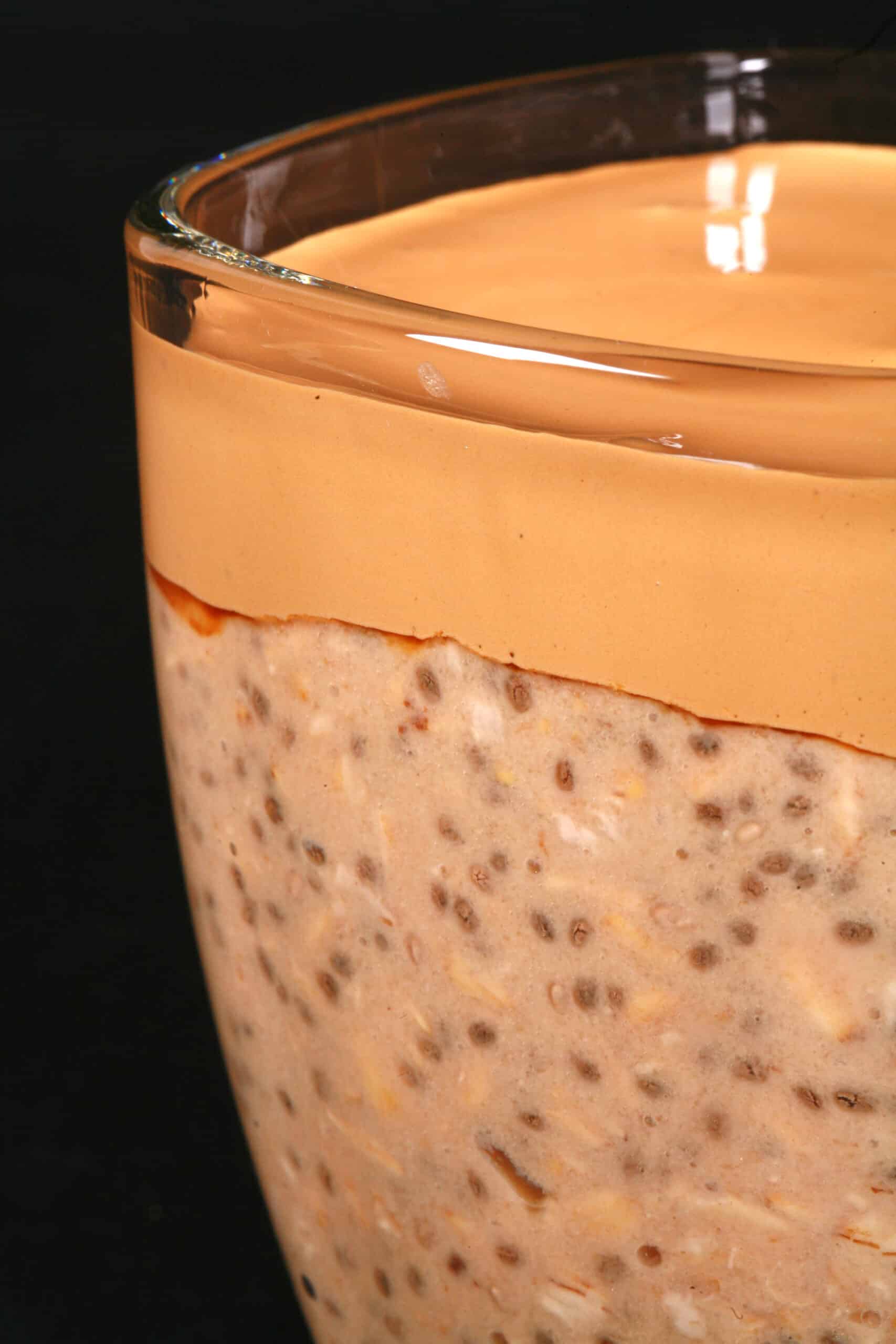A mug of Dalgona Coffee High Protein Overnight Oats.