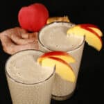 2 ginger high protein peach matcha smoothies, with fresh peaches and ginger root.
